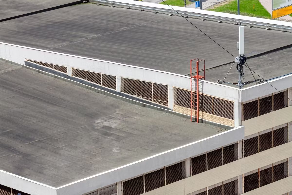 Roofing contractor documenting commercial roof damage in Fort Myers for an insurance file
